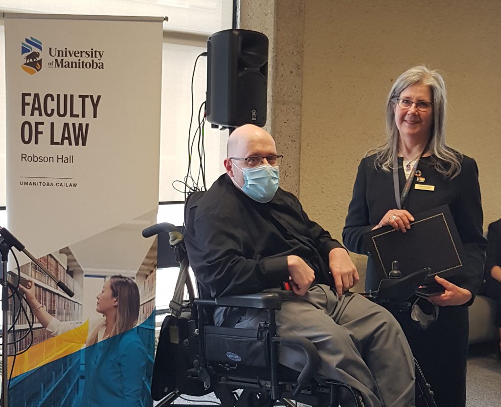 Professor Lorna Turnbull is presented with a Faculty Service Award by Professor Darcy MacPherson.